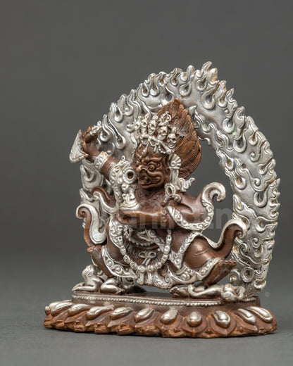 Sacred Mahakala Bernagchen protector statue showing crushed evil entities, Tibetan Buddhist ritual sculpture for altar