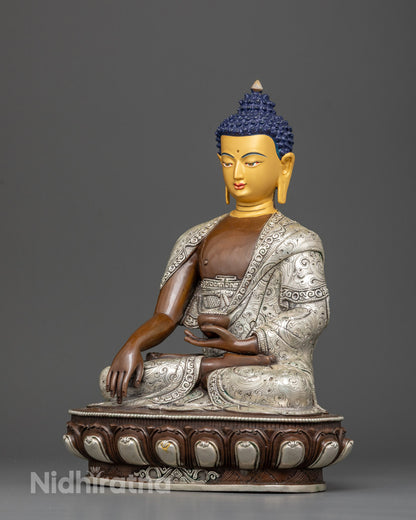A hand-carved Shakyamuni Buddha statue seated in a meditative posture, crafted from oxidized copper with 24k gold and silver-plated details, symbolizing peace and enlightenment.