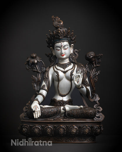 White Tara's serene face and jeweled crown, showcasing intricate craftsmanship and traditional Tibetan artistry.