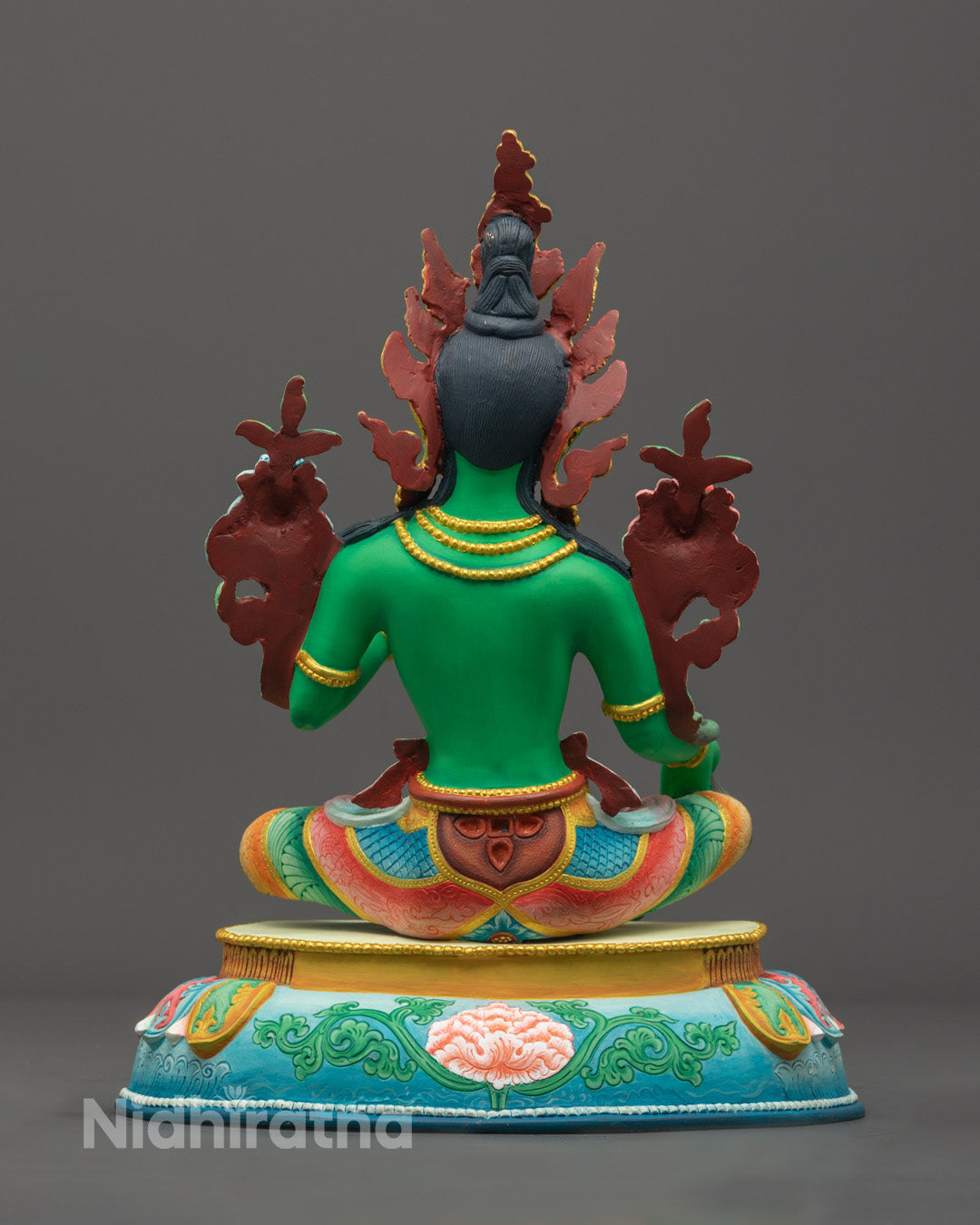 Sacred hollow chamber at base of Green Tara statue for storing mantras or relics, following Tibetan Buddhist traditions