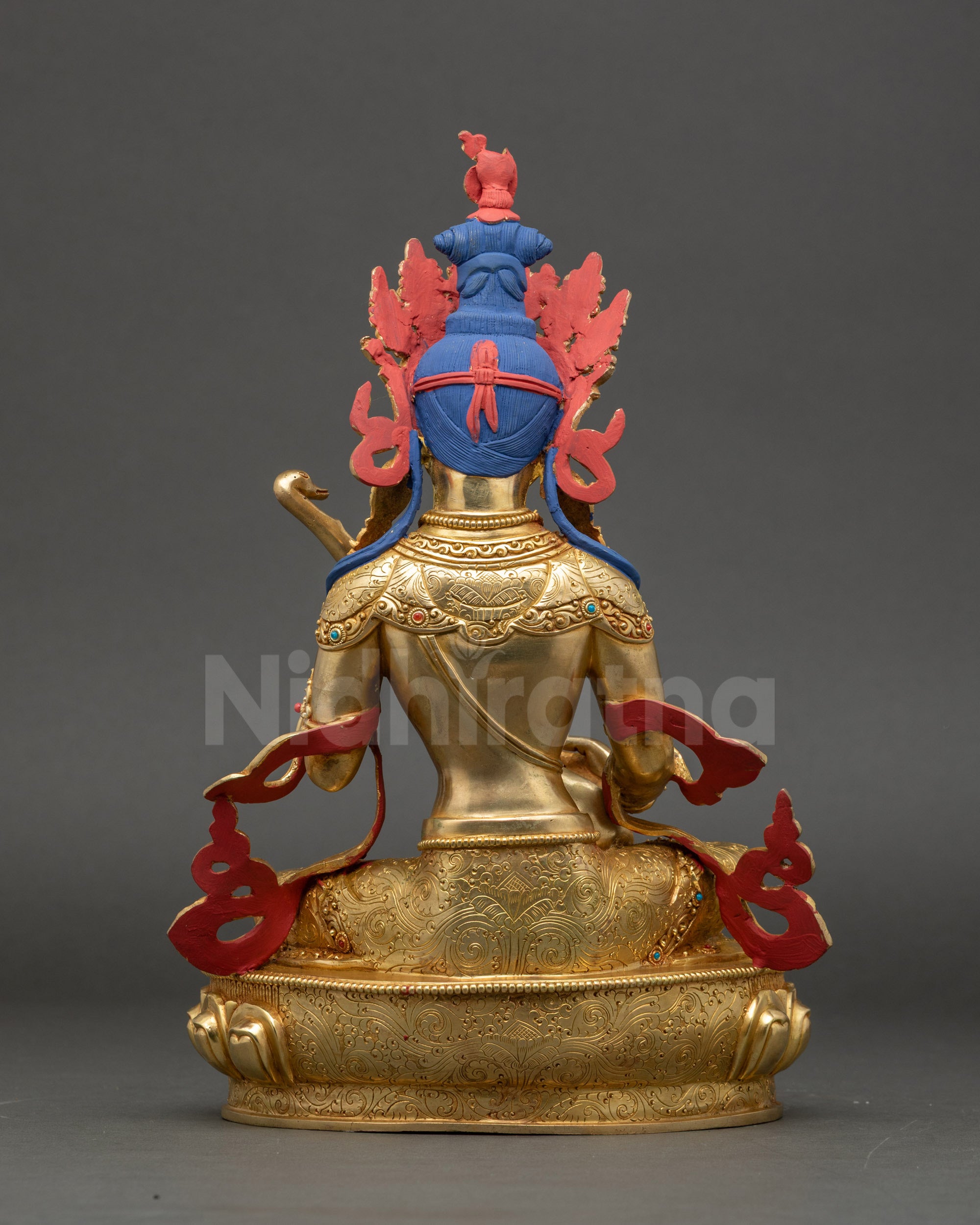 Saraswati statue back view revealing fire-gilded body and traditional Nepalese detailing