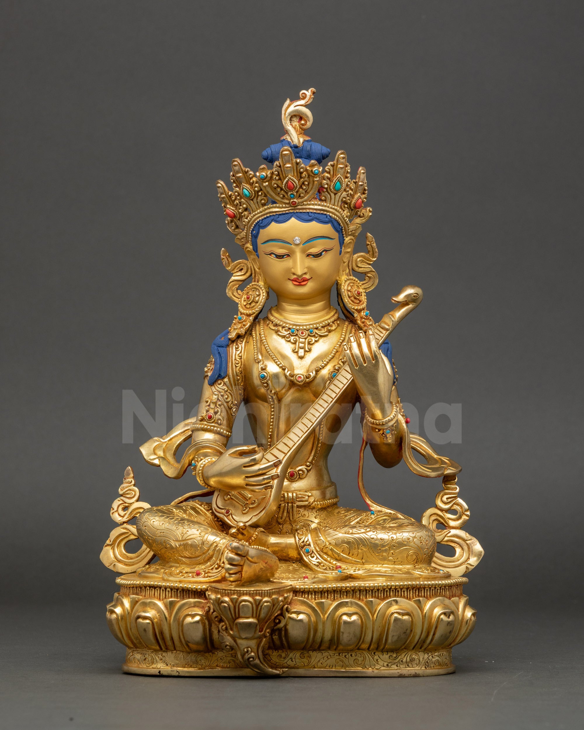 Saraswati statue front view with gold-gilded face and jeweled crown, handcrafted in Nepal
