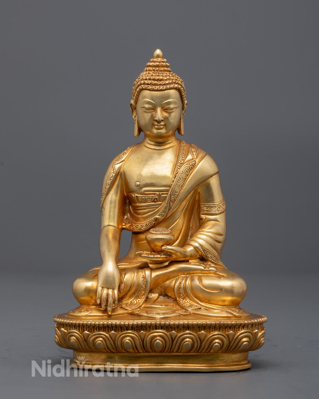 Seated Buddha Shakyamuni Sculpture – Tibetan hand-carved statue with gold-gilded face, fire-gilded body, and patra bowl representing spiritual renunciation and enlightenment.