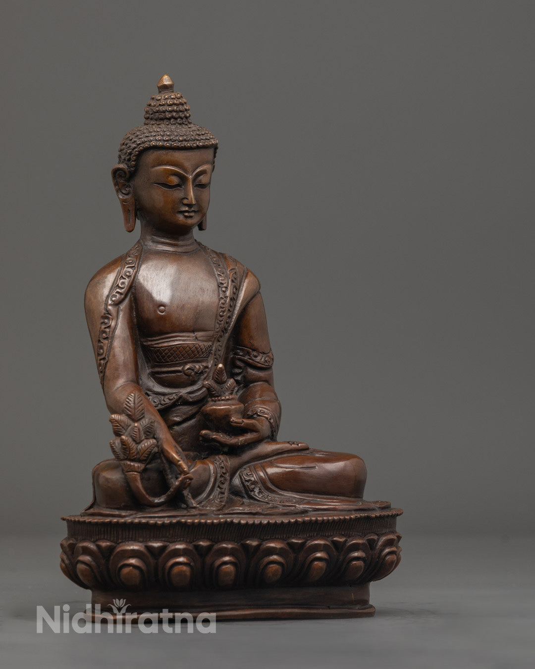 Serene Shakyamuni Buddha statue hand-carved from oxidized copper, seated in earth-touching mudra on lotus base, hollow for sacred mantra placement.