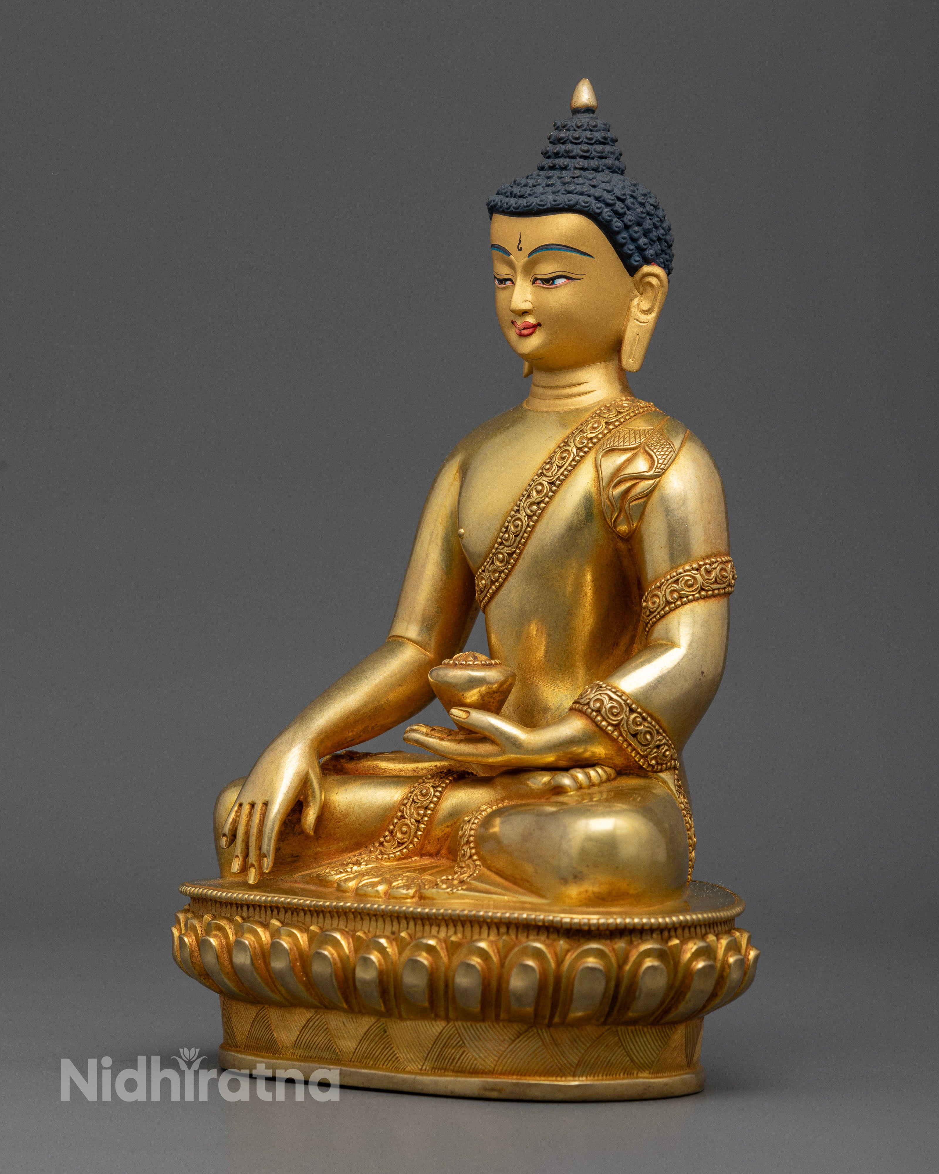 Shakyamuni Buddha holding traditional begging bowl on lotus pedestal.
