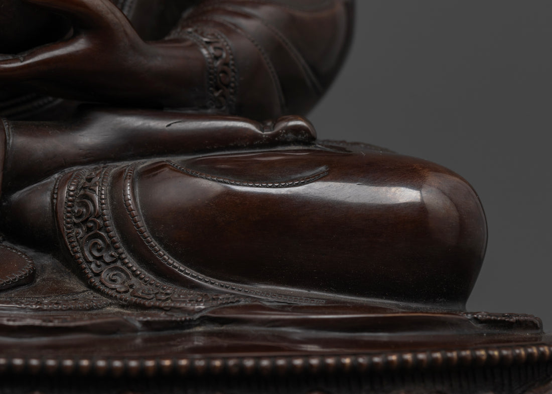 crossed leg of Shakyamuni Buddha statue made of oxidized copper