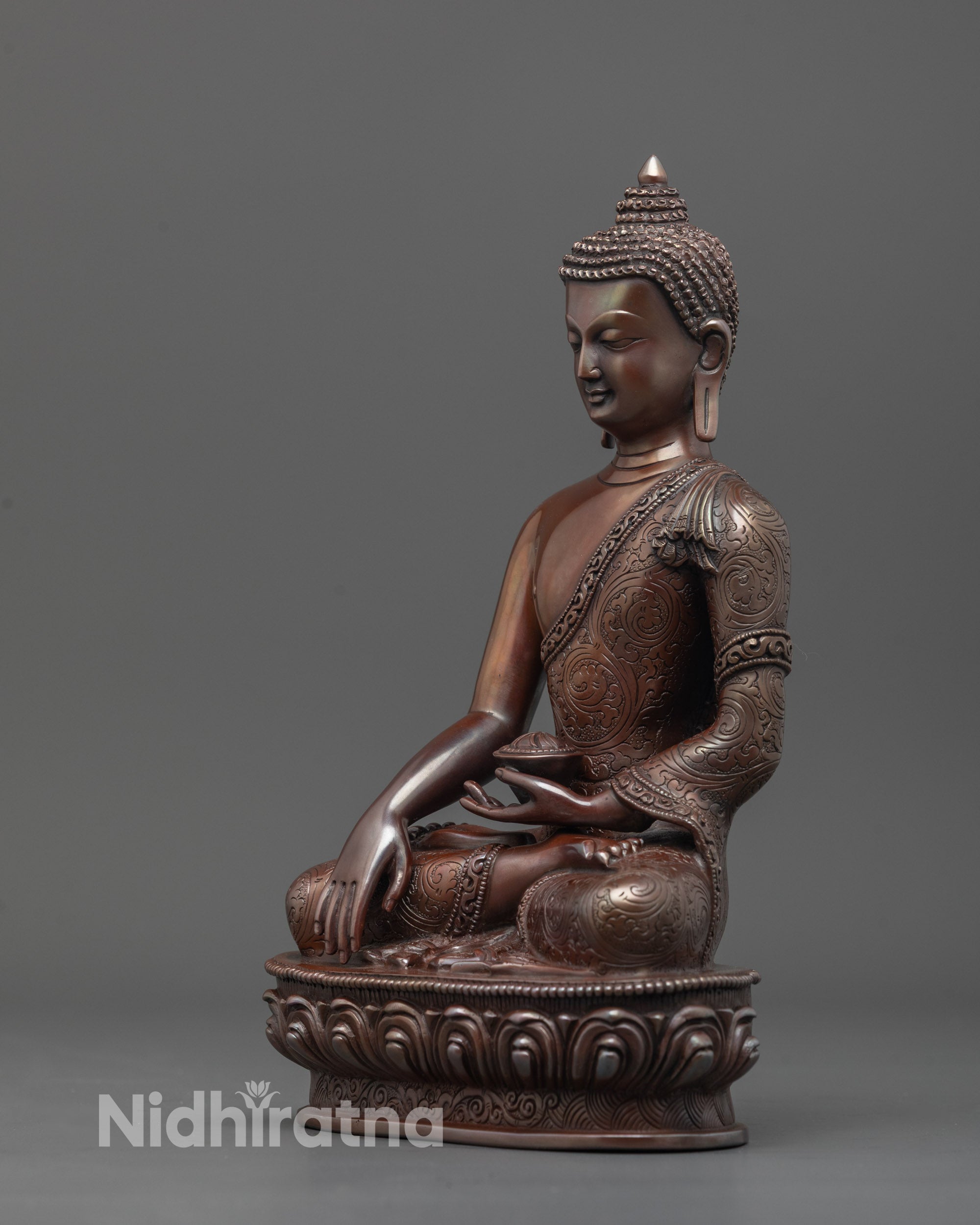 side view of oxidized shakyamuni buddha statue showing monk’s robe and intricate details