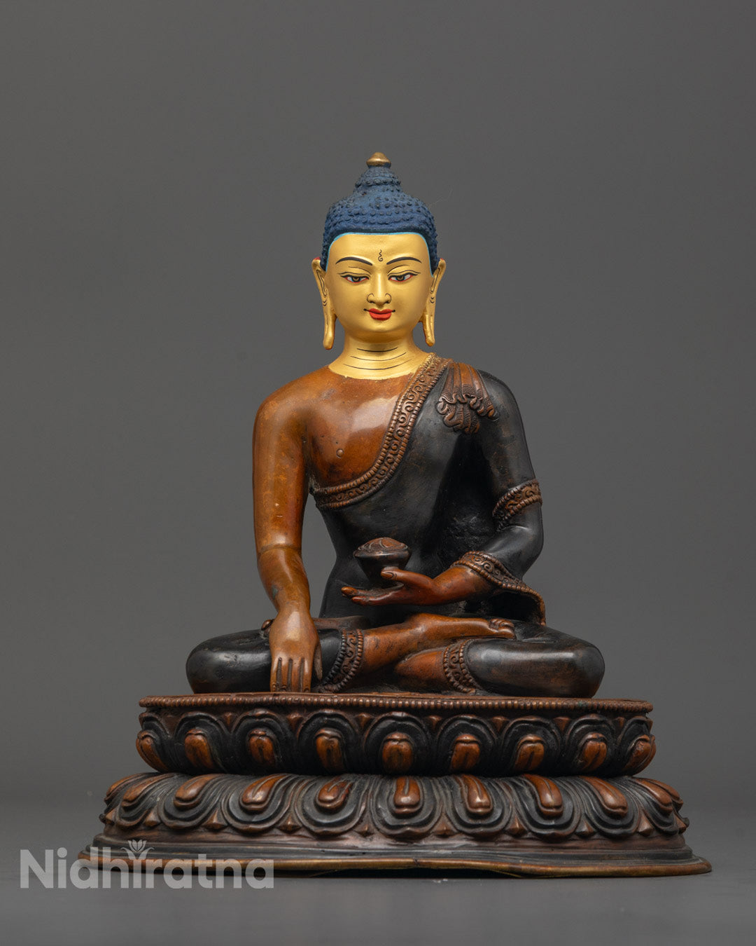 Front view of Tibetan Shakyamuni Buddha statue with 24K gold face and oxidized copper body