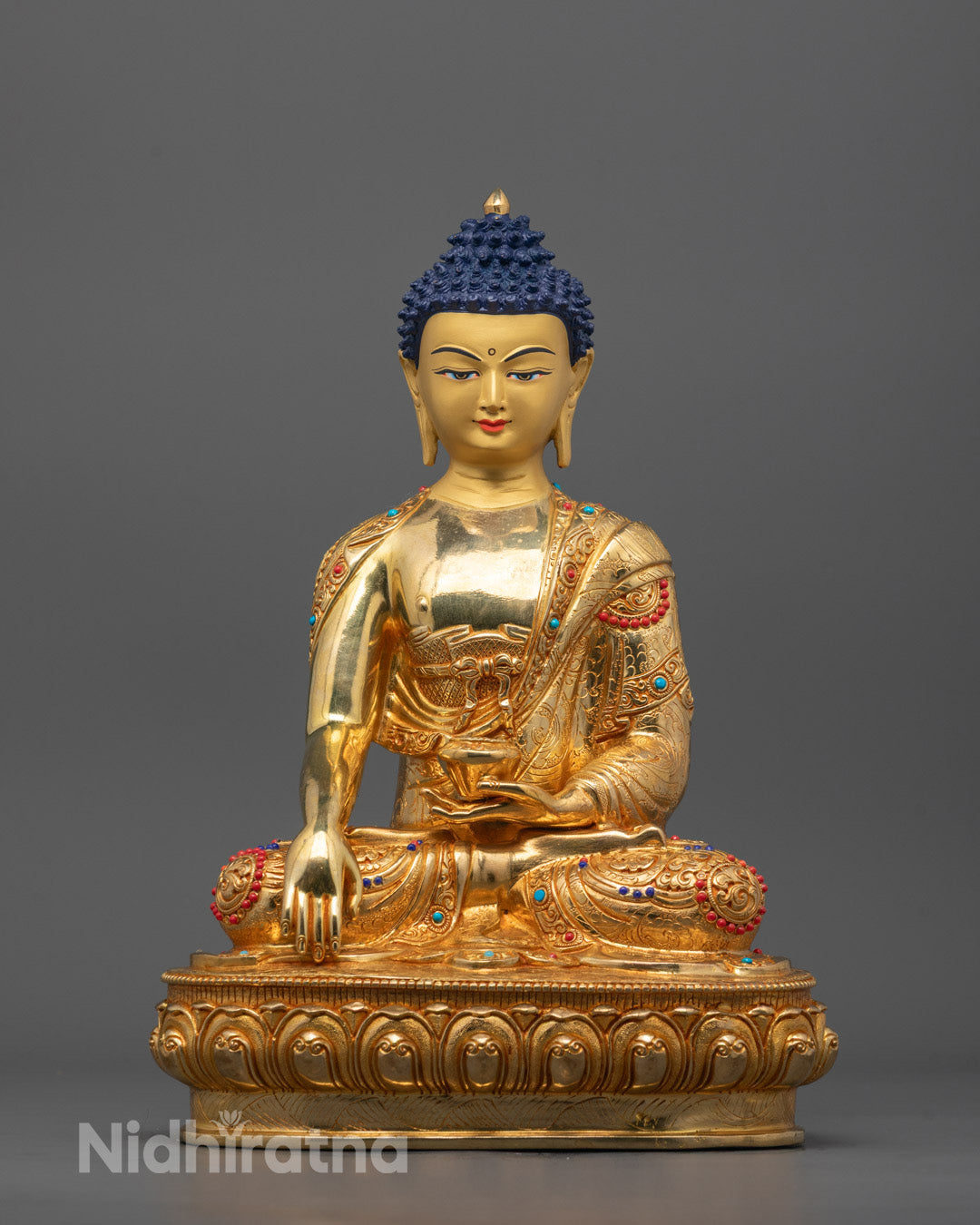 front view of Shakyamuni Buddha Statue with 24K gold face and fire-gilded body, seated on throne
