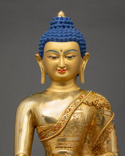 Close up of Lord Gautam Buddha statue showing serene 24K gold painted face