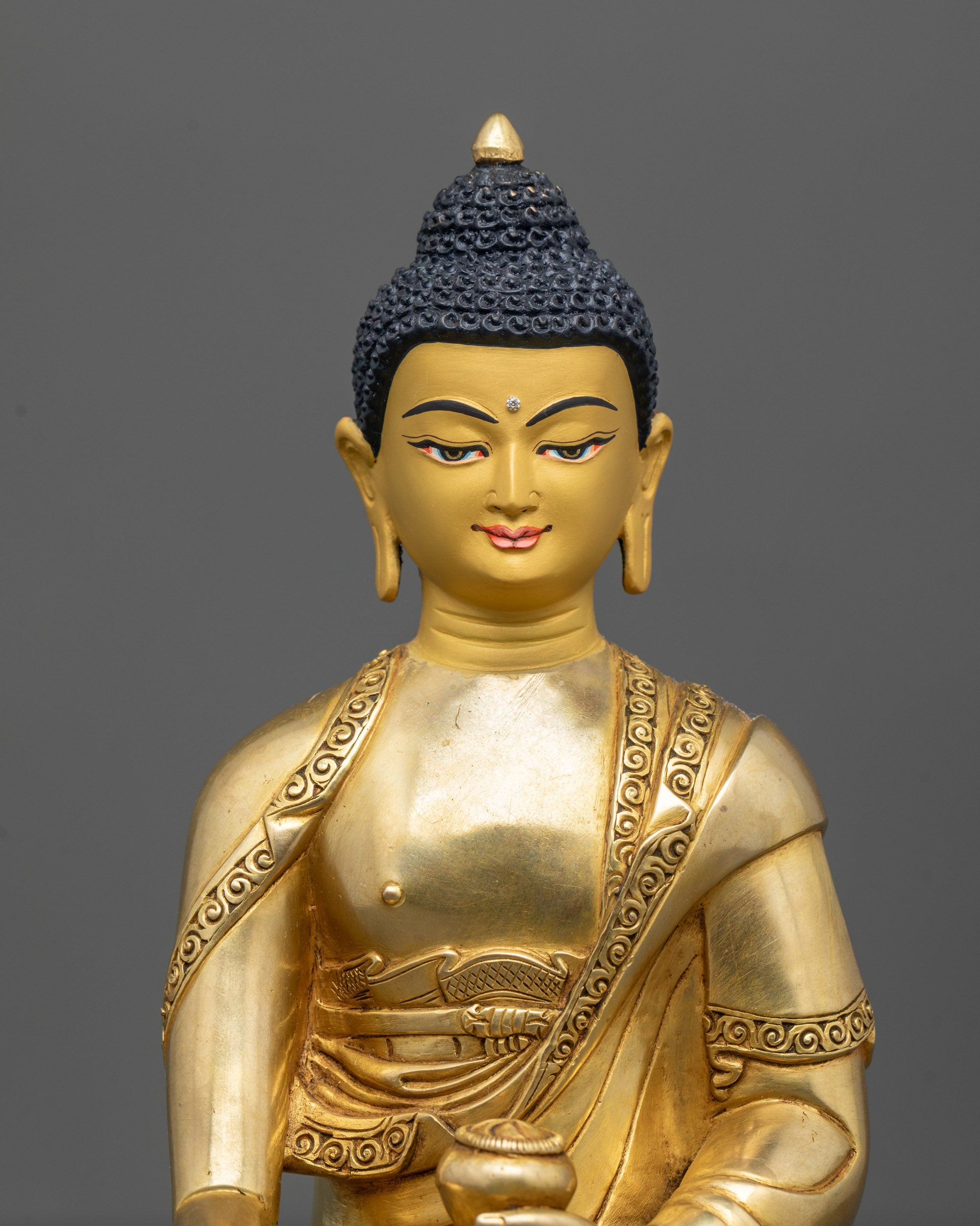 Close-Up of Shakyamuni Buddha Face with 24k Gold Gilding and Peaceful Expression
