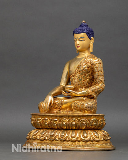 Left side view of Shakyamuni Buddha statue, gold-gilded Nepalese copper, seated meditation posture, detailed robes