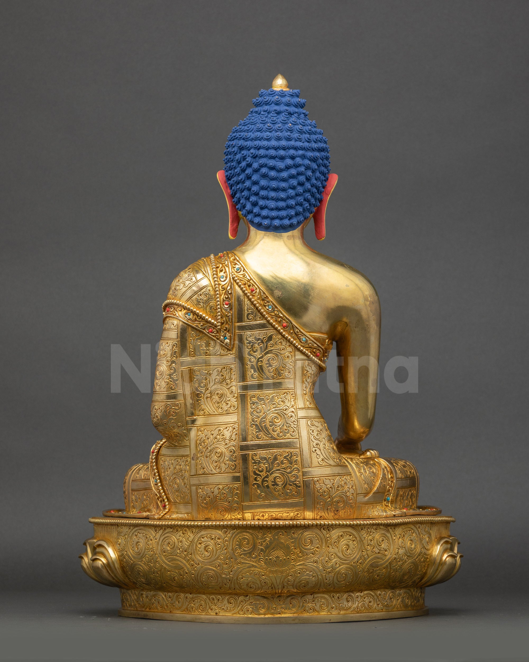 Back view of traditional Tibetan Buddhist Shakyamuni Buddha statue handcrafted in Nepal with detailed robe carving