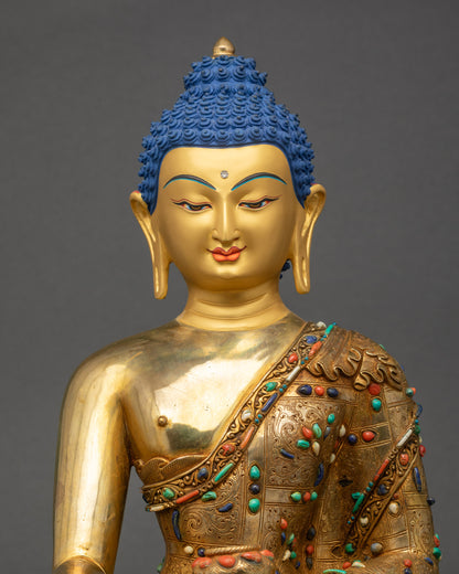 Close-up of Shakyamuni Buddha statue highlighting detailed robe and copper alloy