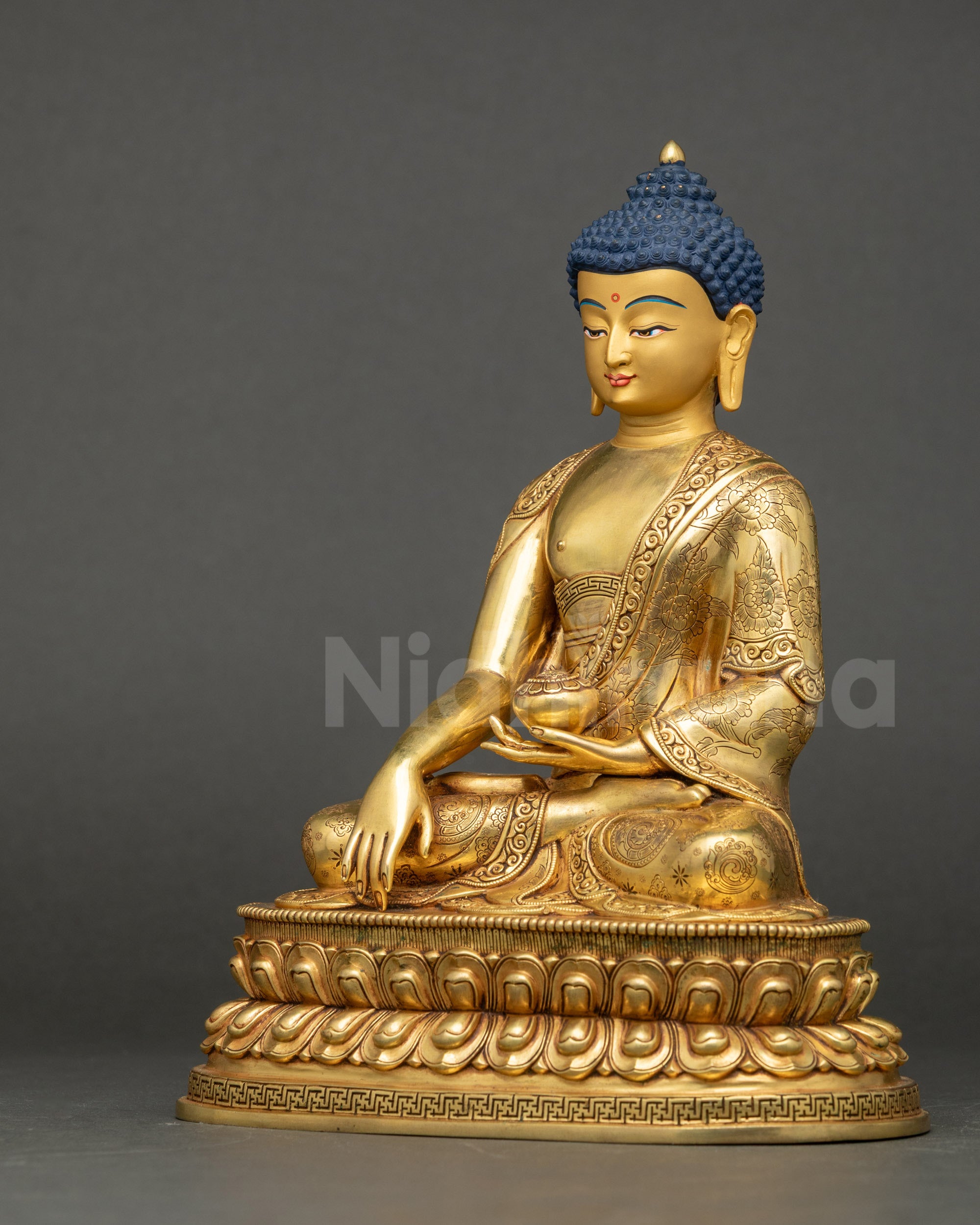Left view showing gold-gilded Buddha statue on lotus with intricate robes.