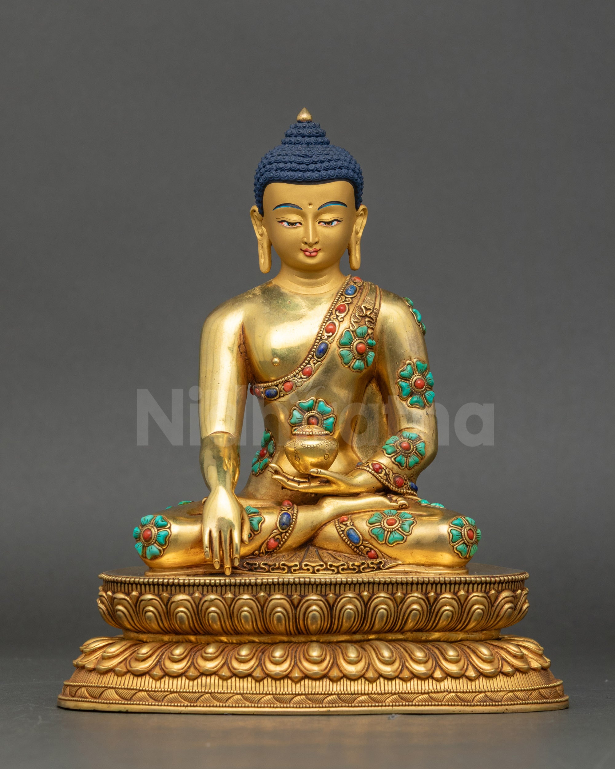 Shakyamuni Buddha Statue from Nepal with gold-painted face and semi-precious stone robe