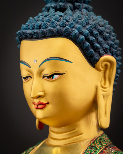 Side close-up of Shakyamuni Buddha face showcasing serene gaze, gold-painted features, and majestic halo