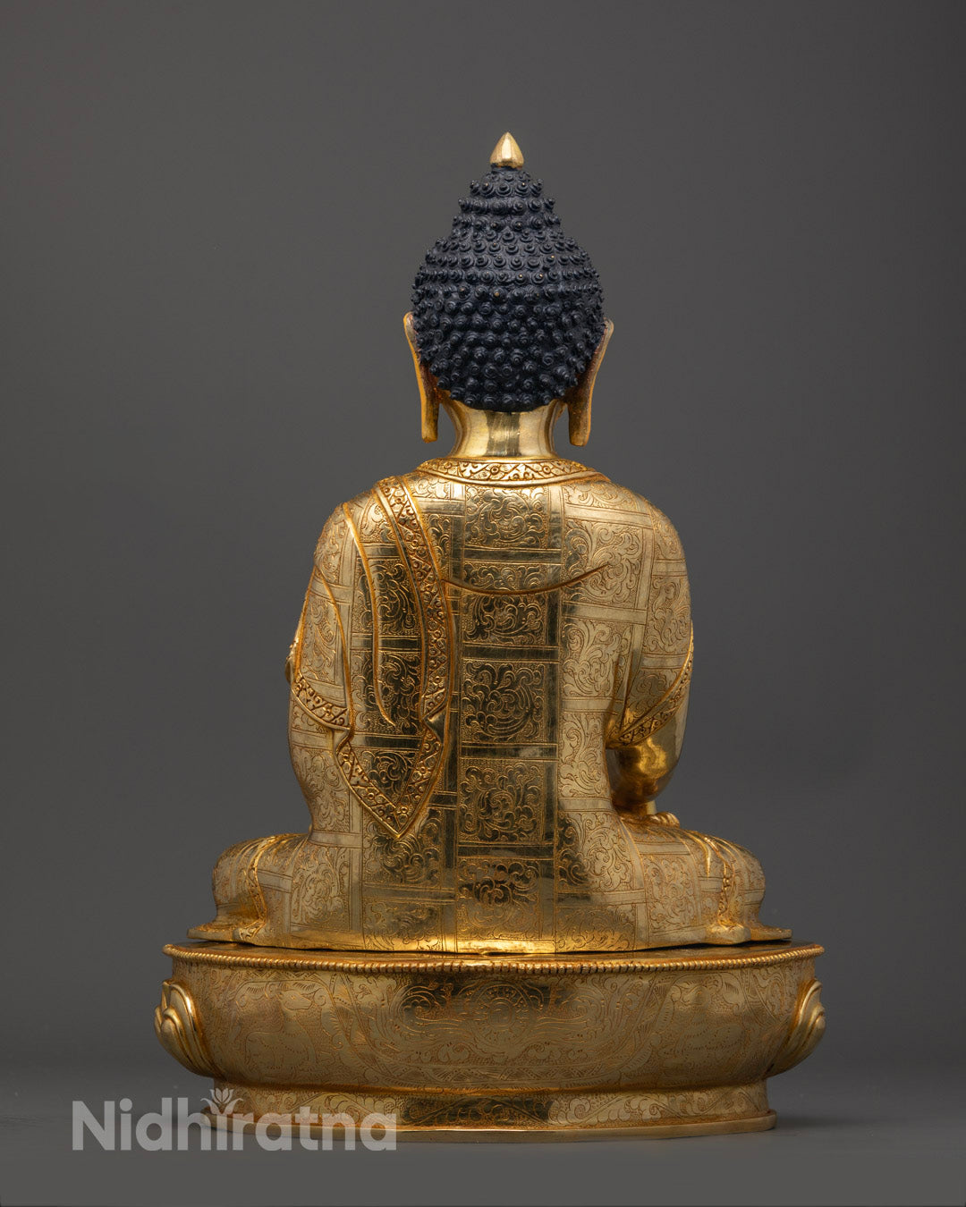 Shakyamuni Buddha Statue showing meditative posture with hollow chamber for mantra placement and vibrant colors