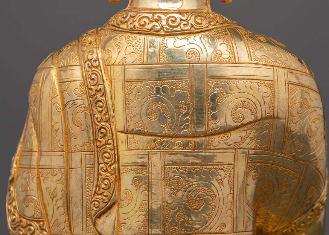 the shoulder and back side of gold plated Shakyamuni Buddha statue