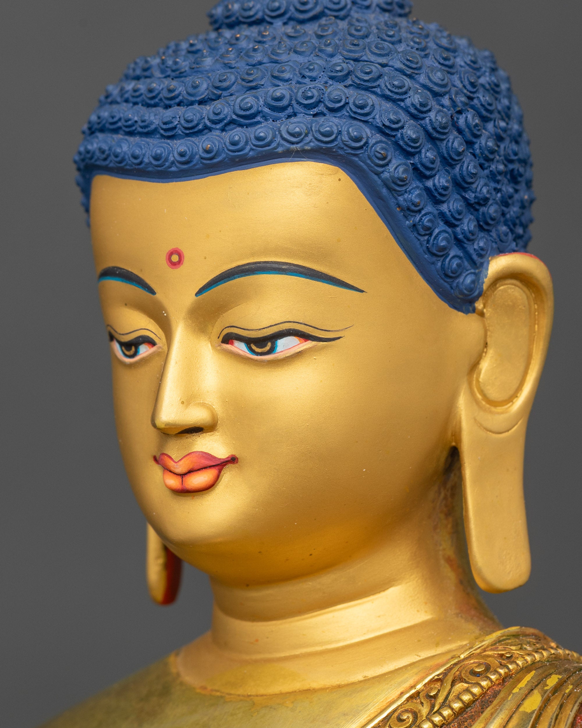 Shakyamuni Buddha gold face detailed side close up with lotus seat
