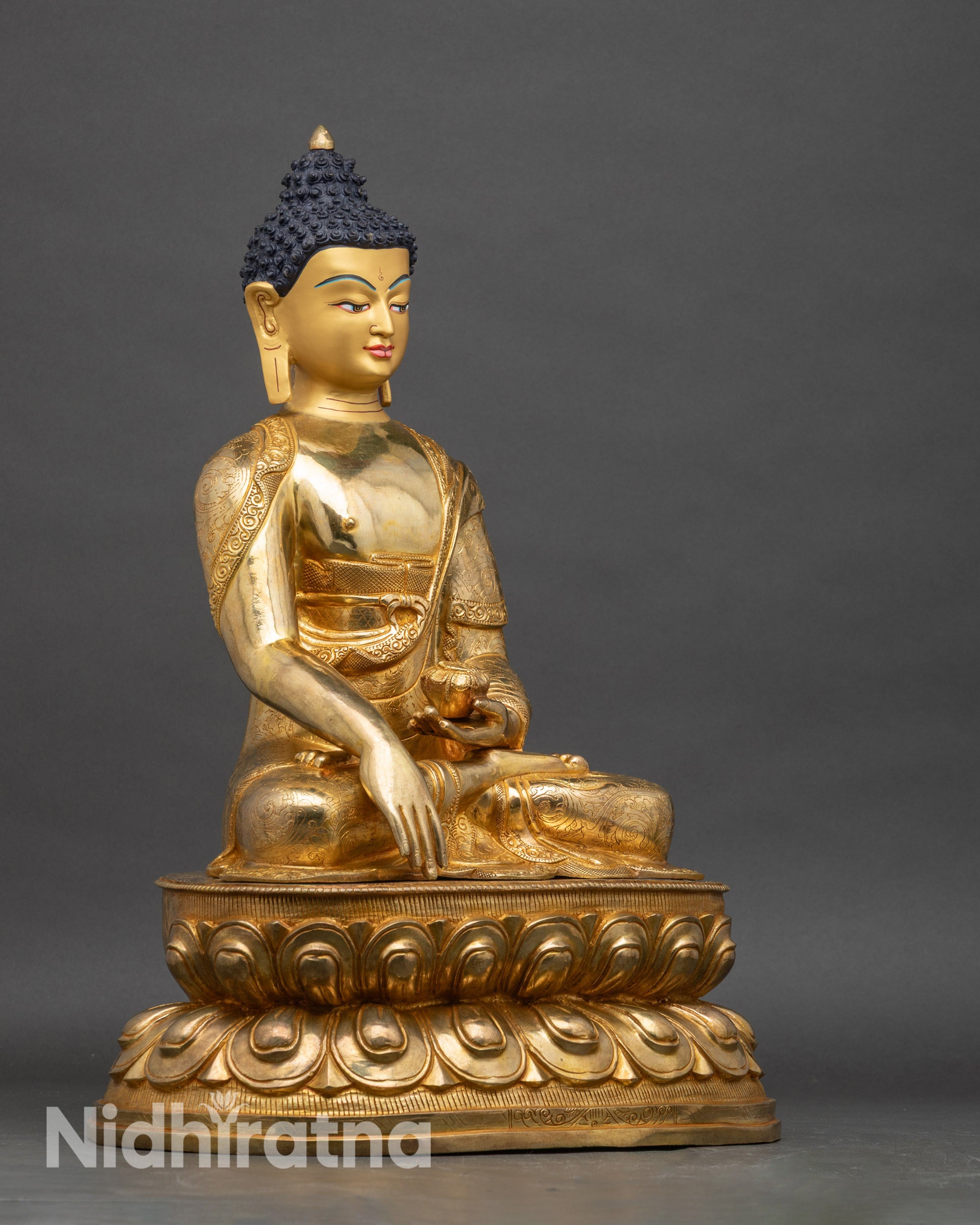 Shakyamuni Buddha right profile, copper statue with lotus seat and gold accents