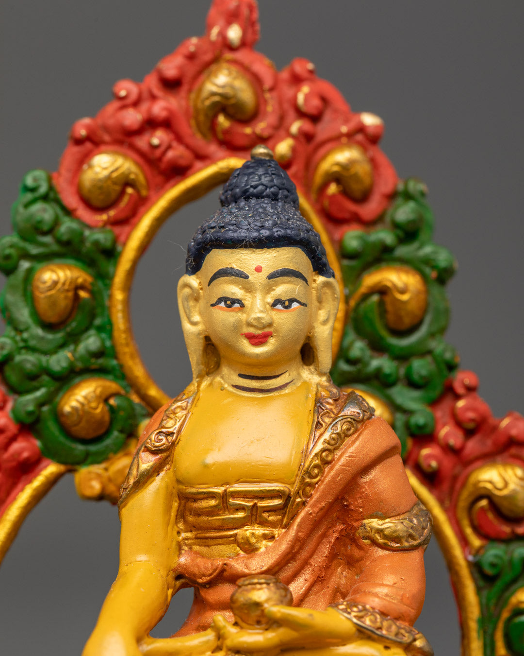 Shakyamuni Buddha sculpture seated on moon disc lotus under Buddhist lion thrones holding sacred patra begging bowl symbolizing compassion and humility