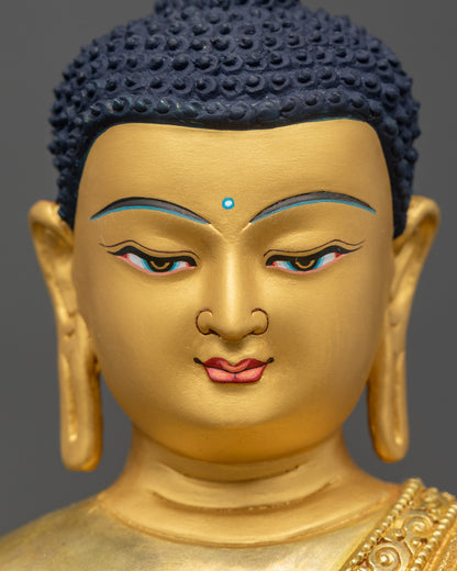 Shakyamuni Buddha statue detailed close up face with serene gold-painted expression