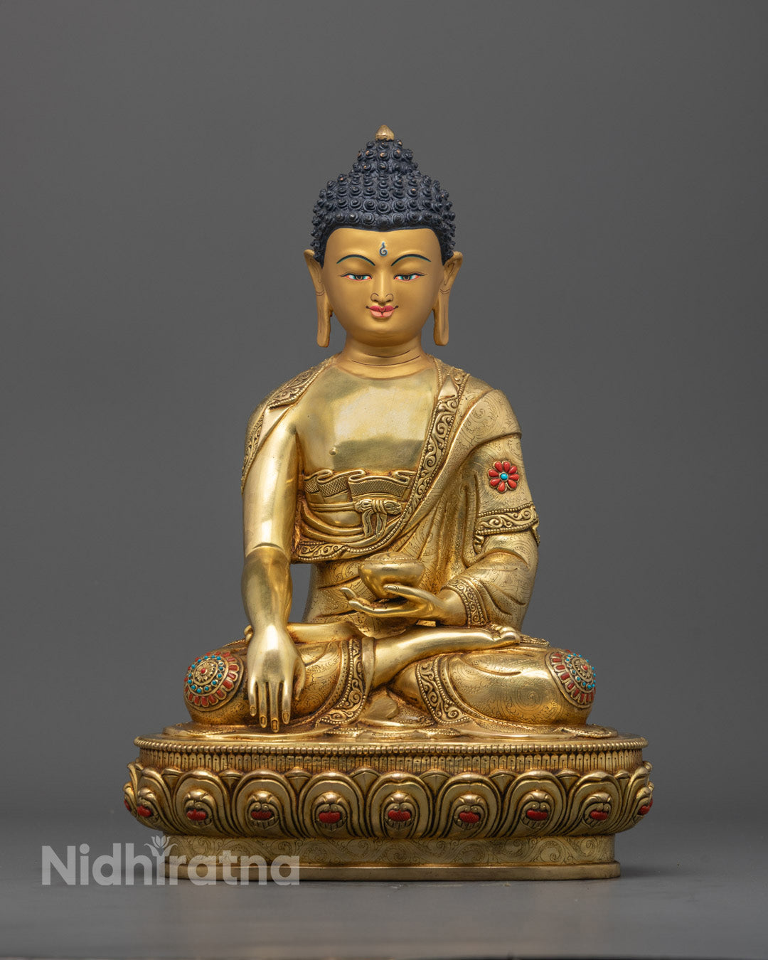 Shakyamuni Buddha statue front view with 24K gold-gilded face and detailed carvings
