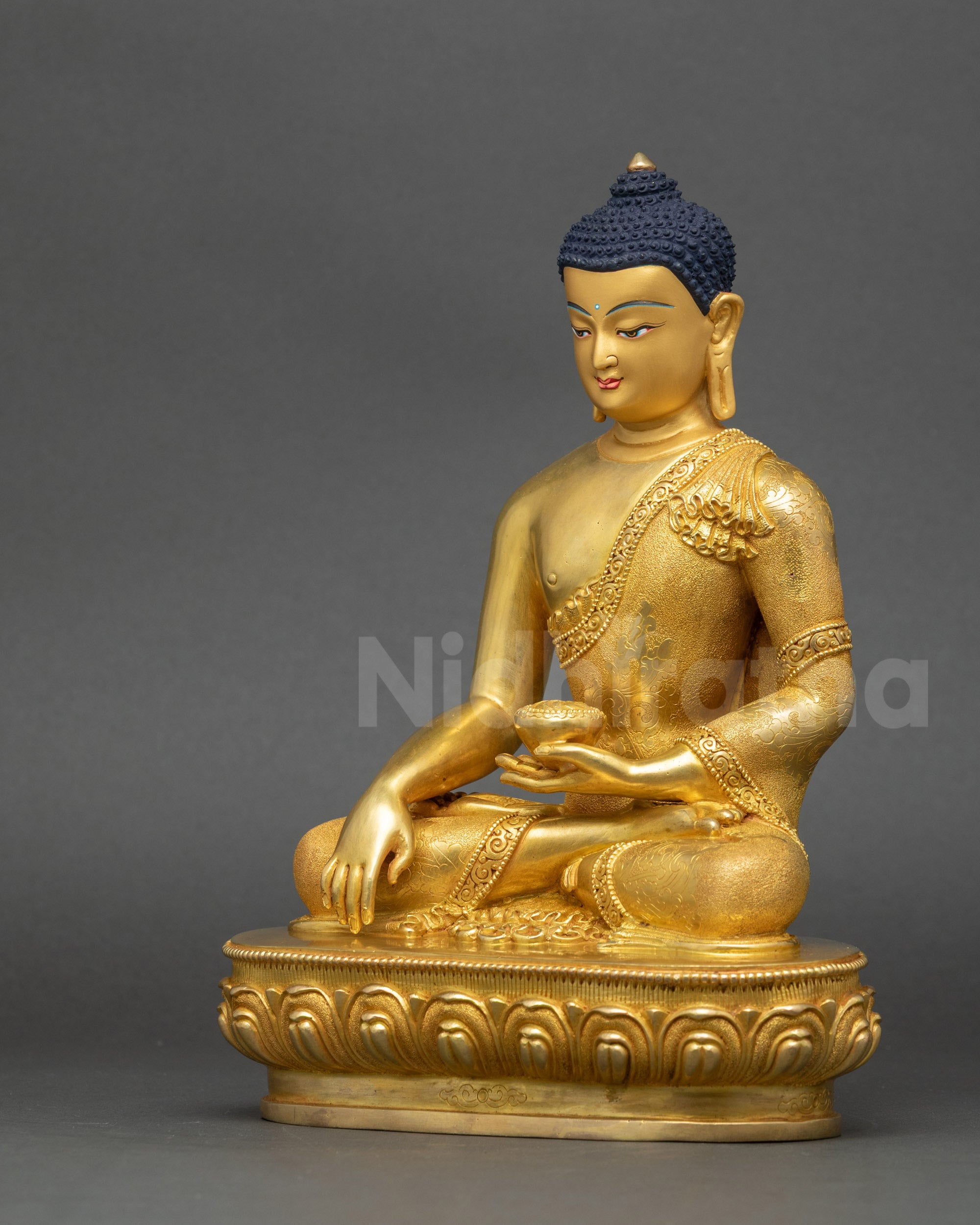 Shakyamuni Buddha statue left view side with intricate garments and calm presence