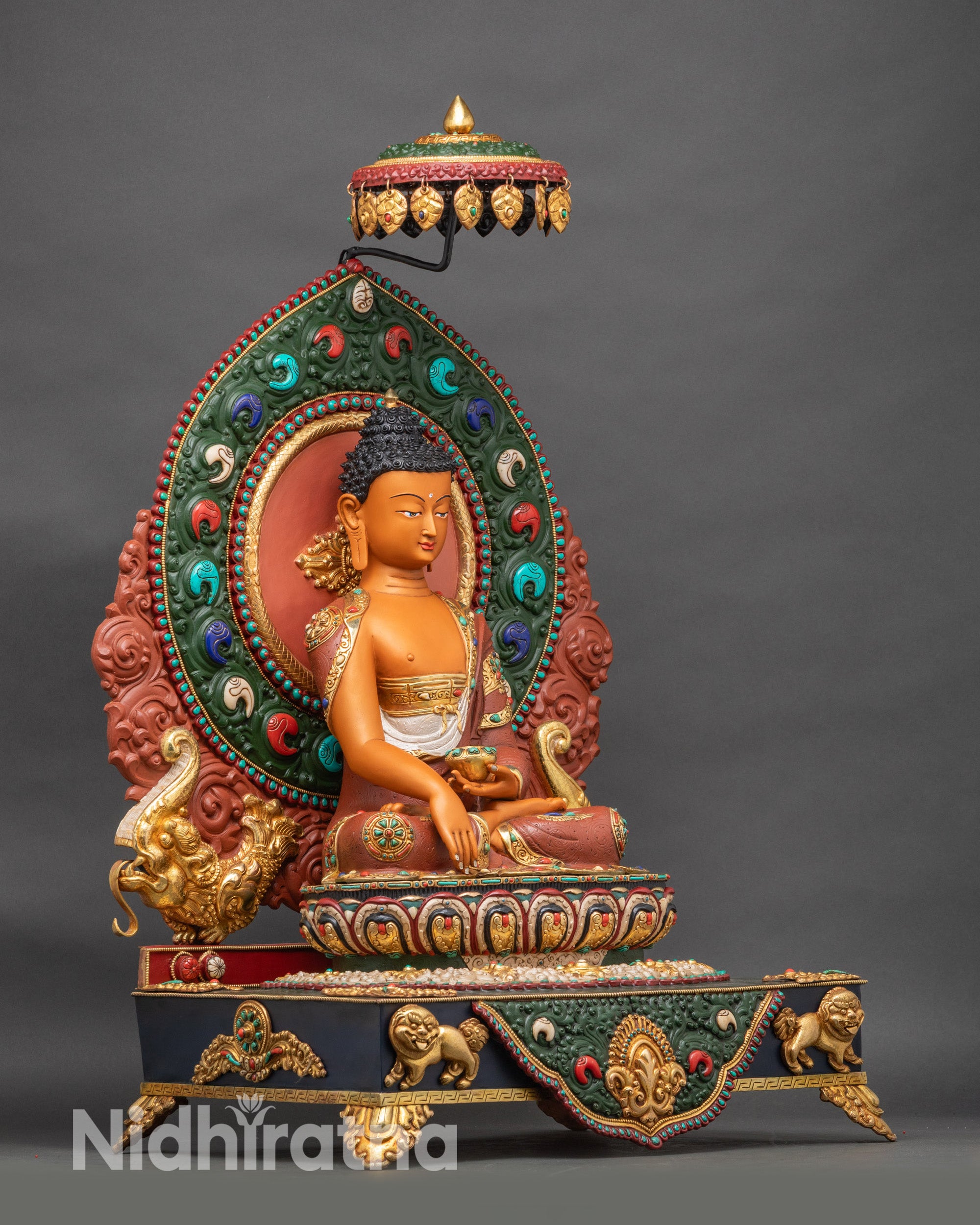 Shakyamuni Buddha viewed from right angle displaying full hand-painted lion throne with turquoise and ruby inlay work