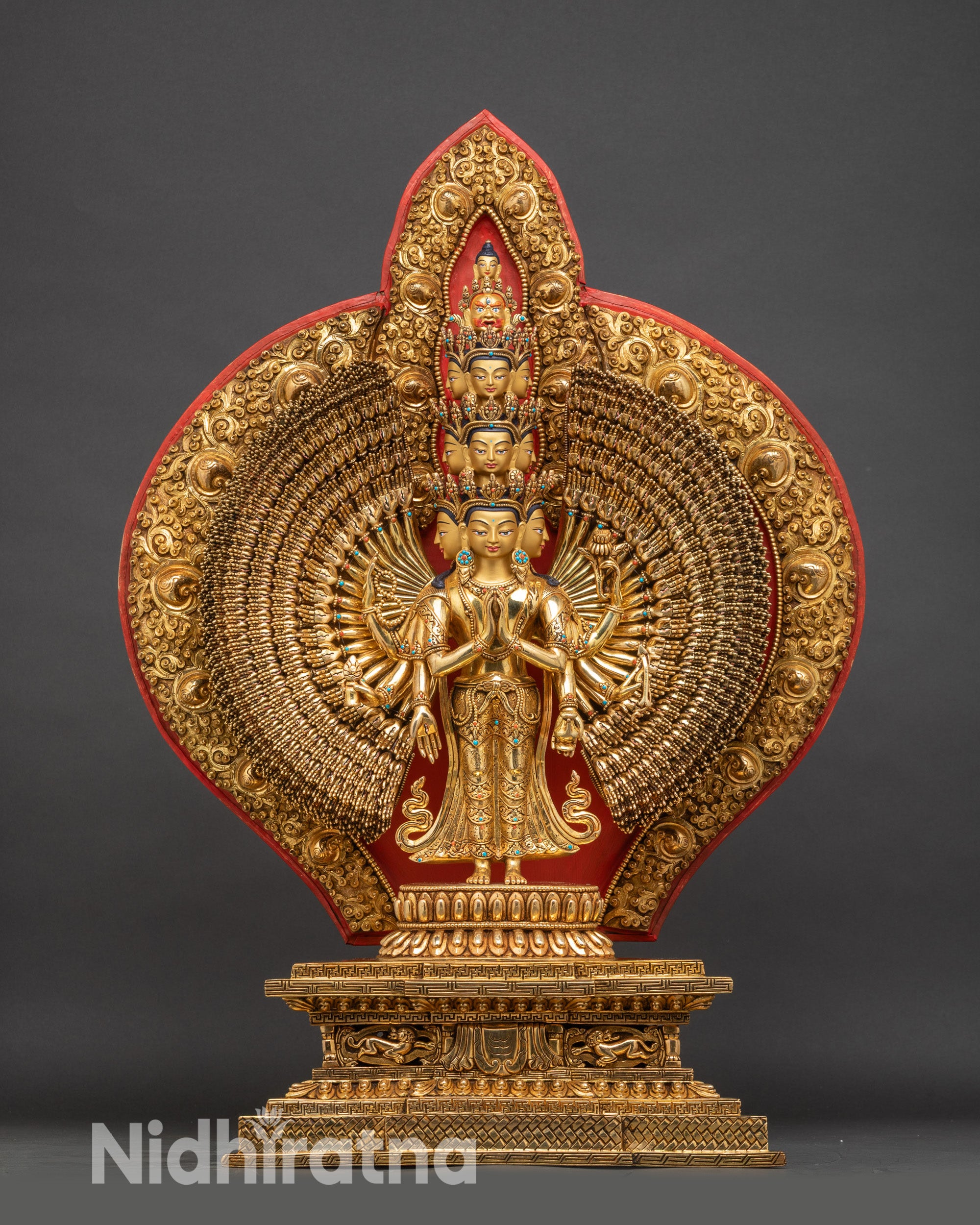 Showing full front of 1000-Armed Chenrezig statue, copper with gold fire-gilding and lotus base