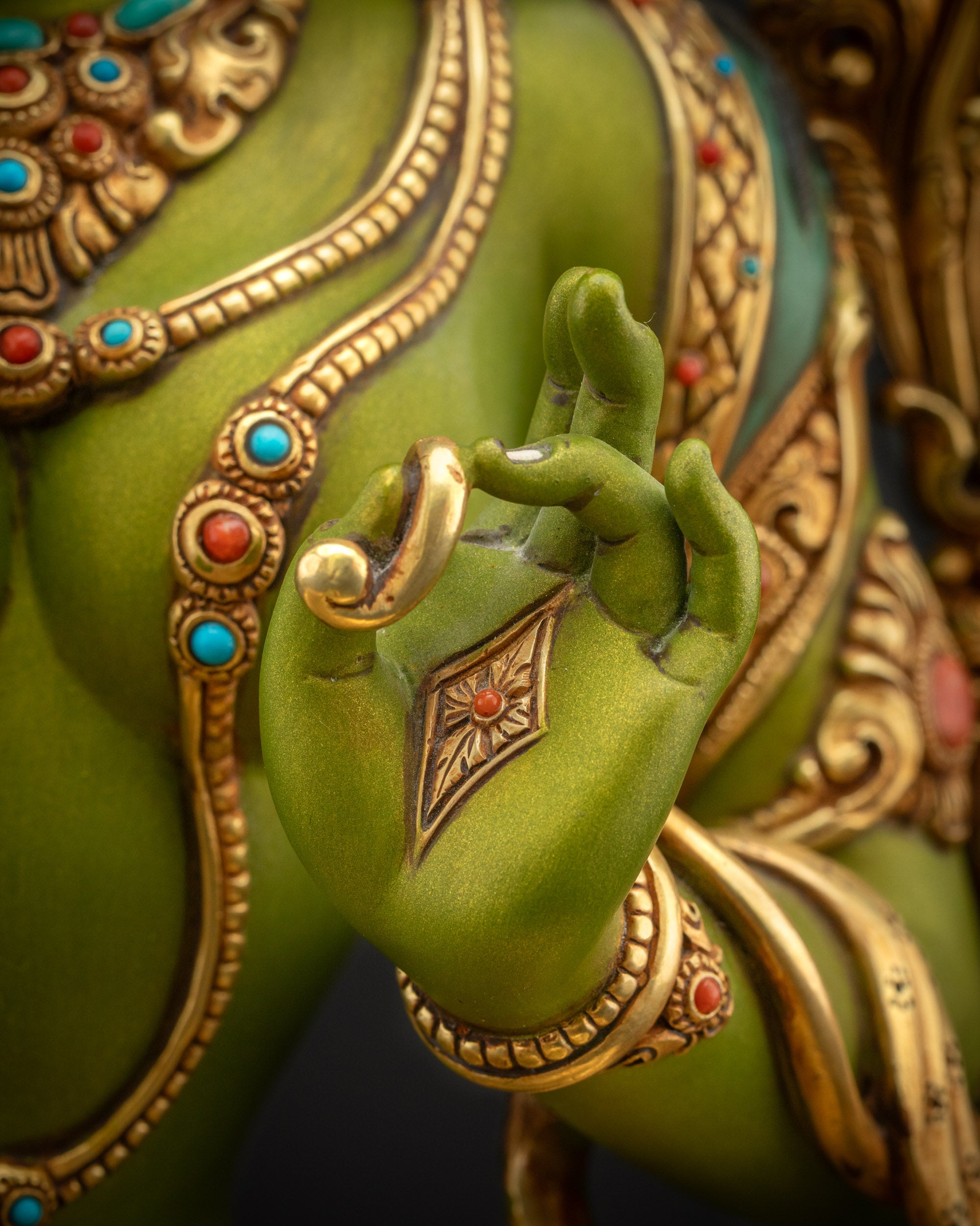 Detailed close up of Shyama Tara statue hand forming abhaya mudra representing protection