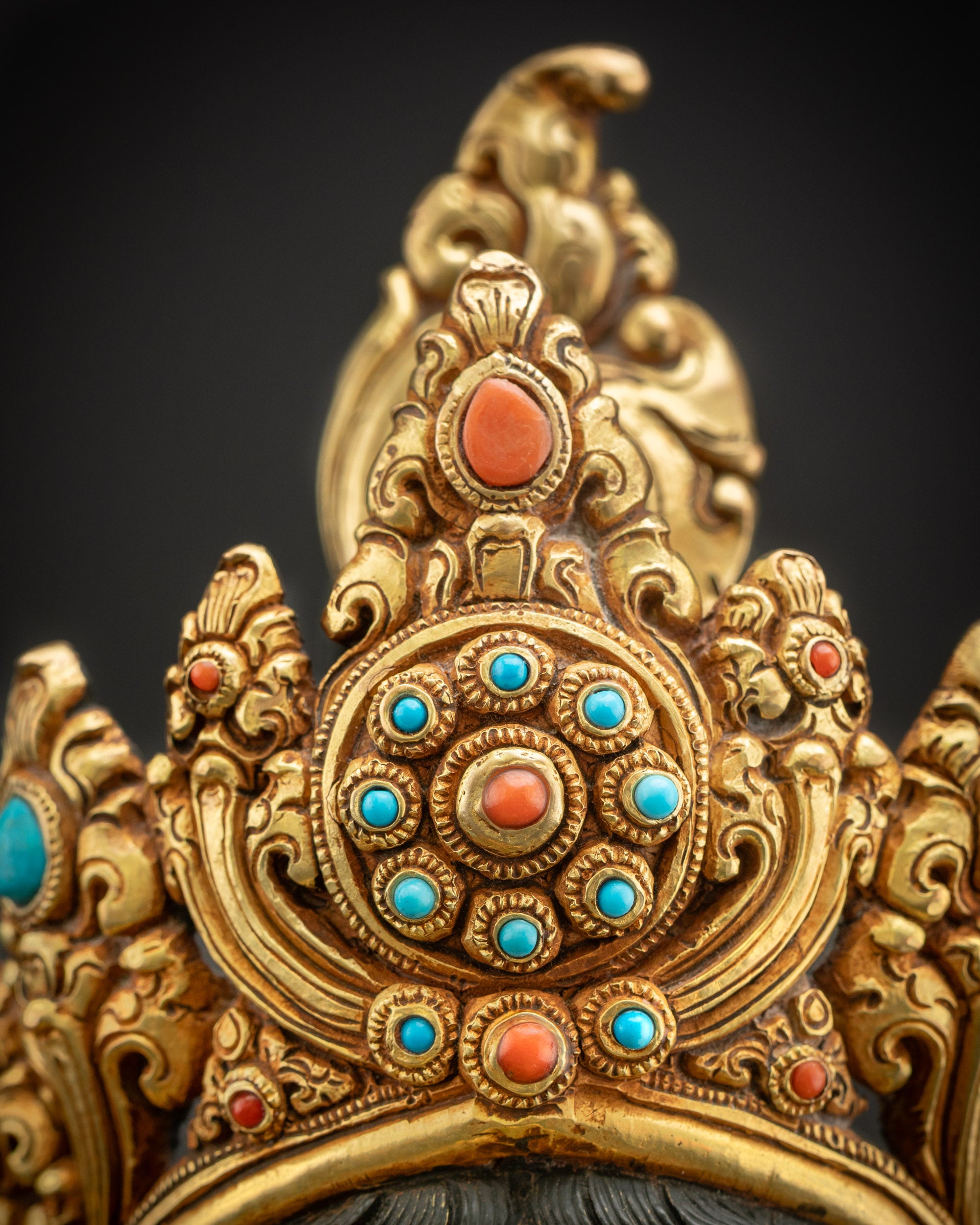 Detailed close up of five pointed crown with gold fire gilding royal ornaments and refined
