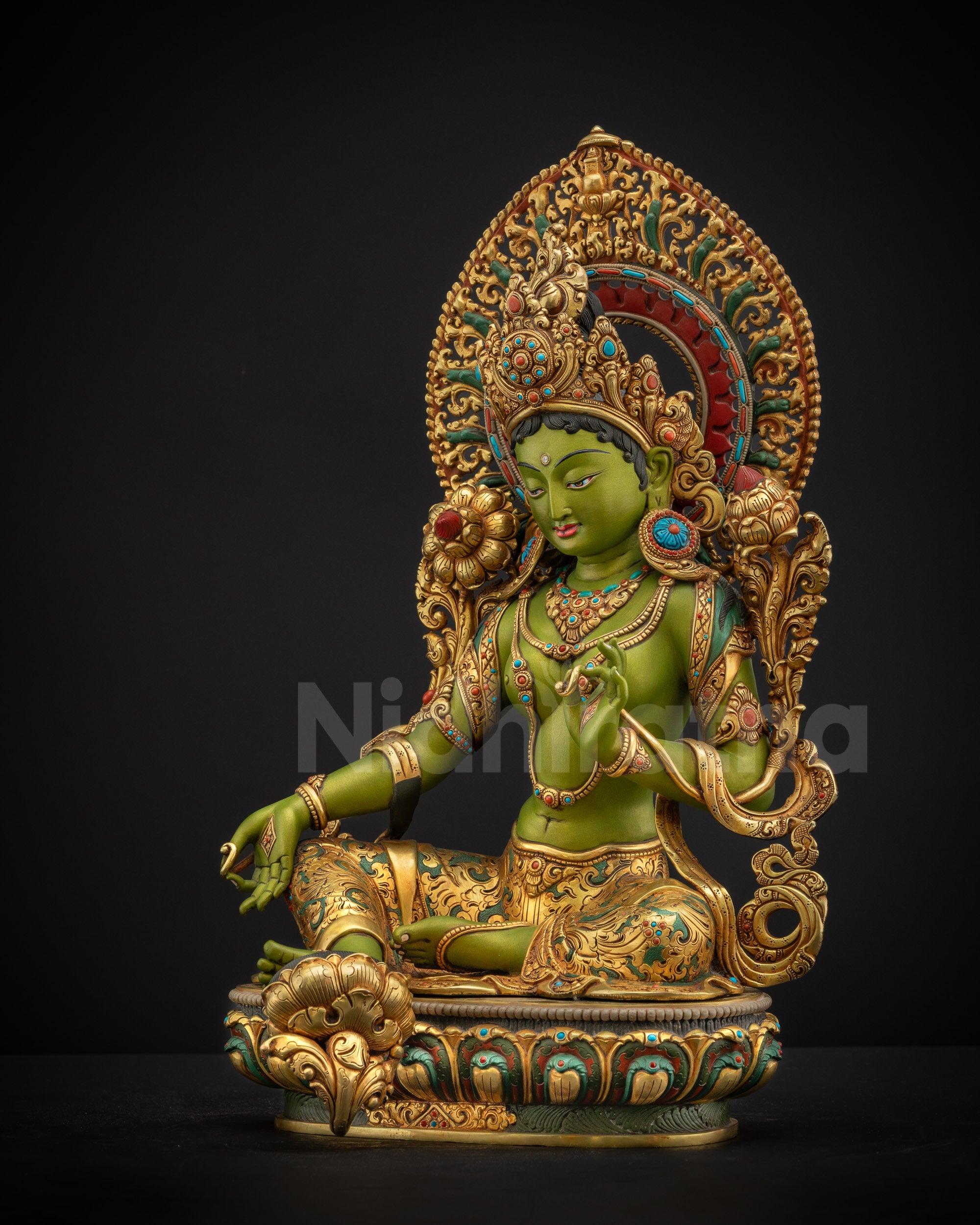 Left side view of Shyama Tara statue showing vitarka mudra elegant posture and layered royal adornments