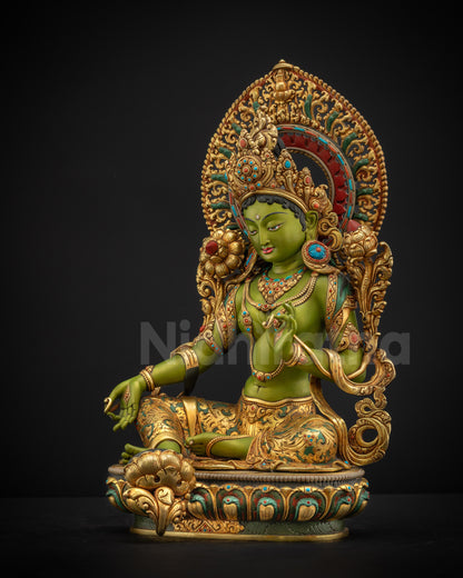 Left side view of Shyama Tara statue showing vitarka mudra elegant posture and layered royal adornments