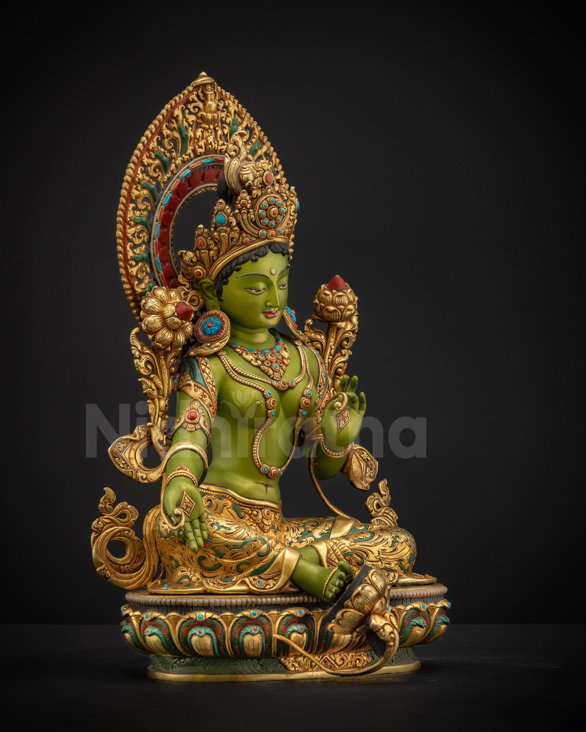 Right side view of Shyama Tara statue displaying utpala flower varada mudra and flowing ornamental details