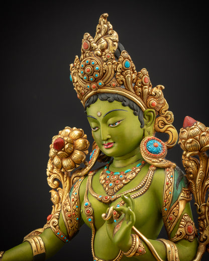 Detailed side close up of Shyama Tara statue revealing intricate filigree robe gold fire gilded ornaments and jewelry