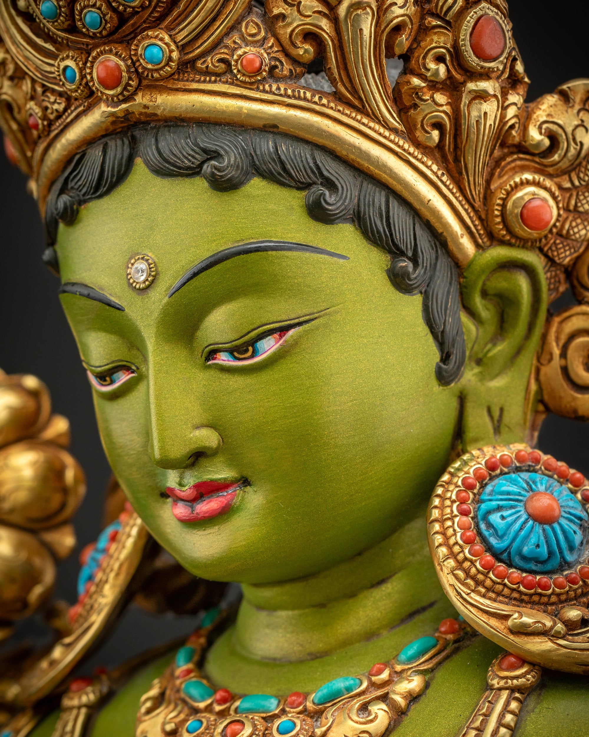 Detailed side face close up of Green Tara statue highlighting calm gaze premium acrylic colors and refined carving
