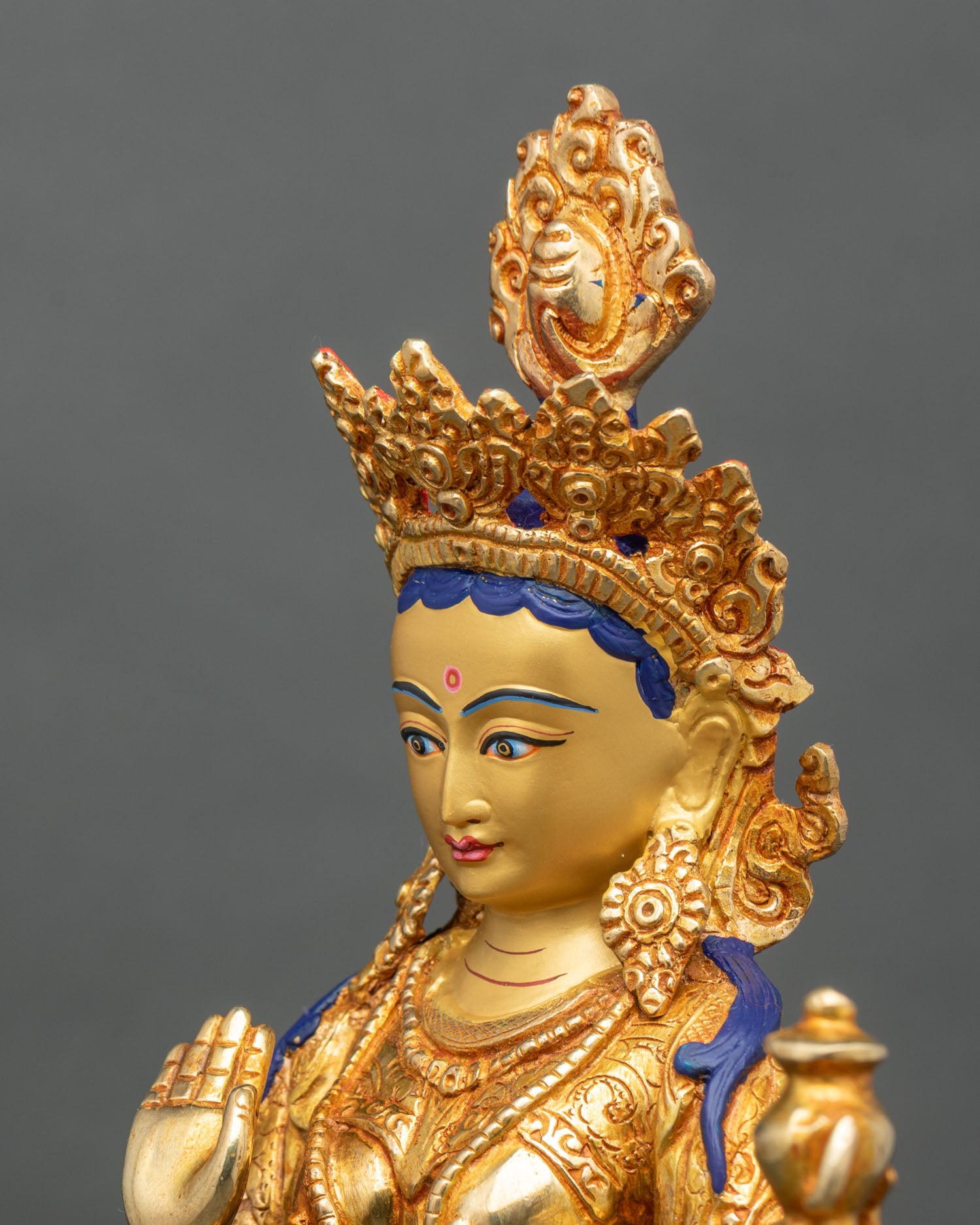 Side close-up of Yeshe Tsogyal statue, flowing robes and engraved floral motifs