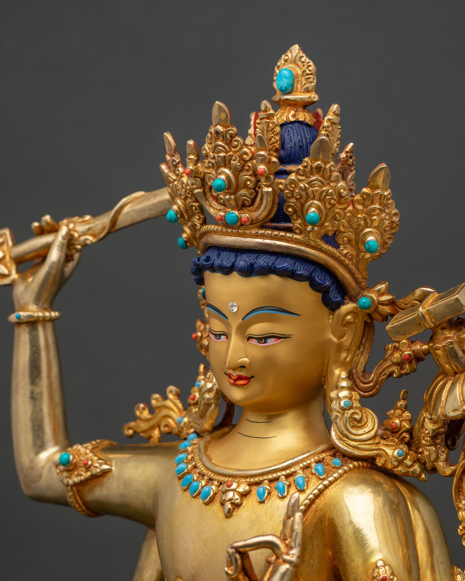 Side detail of Maha Manjushri statue showing bow, arrow and utpala lotus craftsmanship