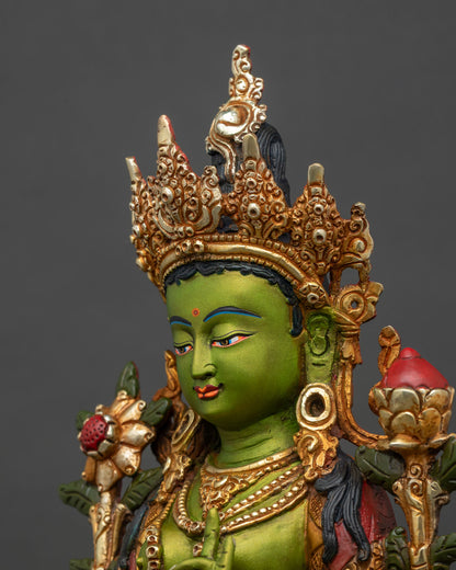 Side close-up of Green Tara statue, ornate lotus seat and sacred Utpala flower