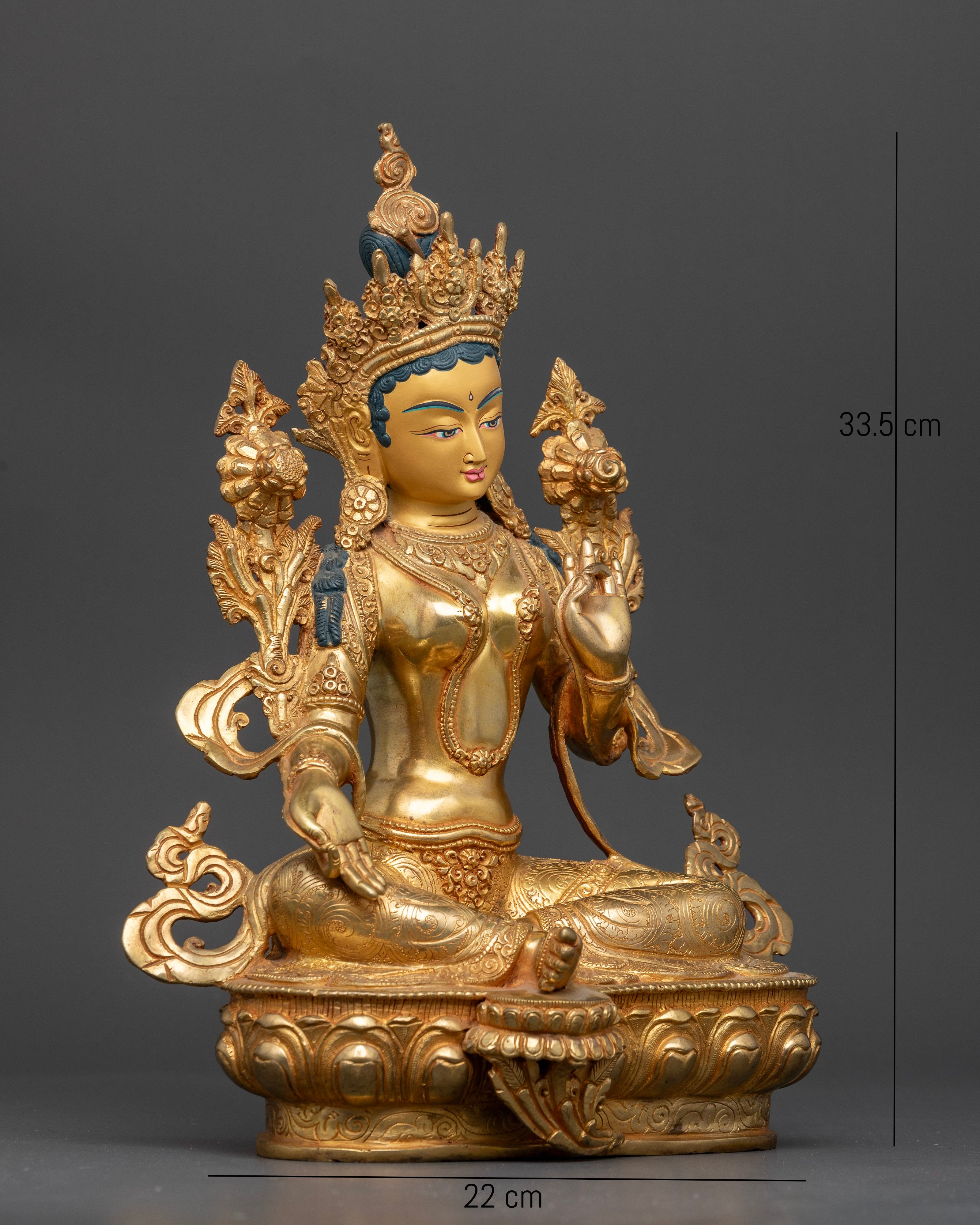 Side view Green Tara sculpture seated on a lotus with flowing robes and floral motifs, copper