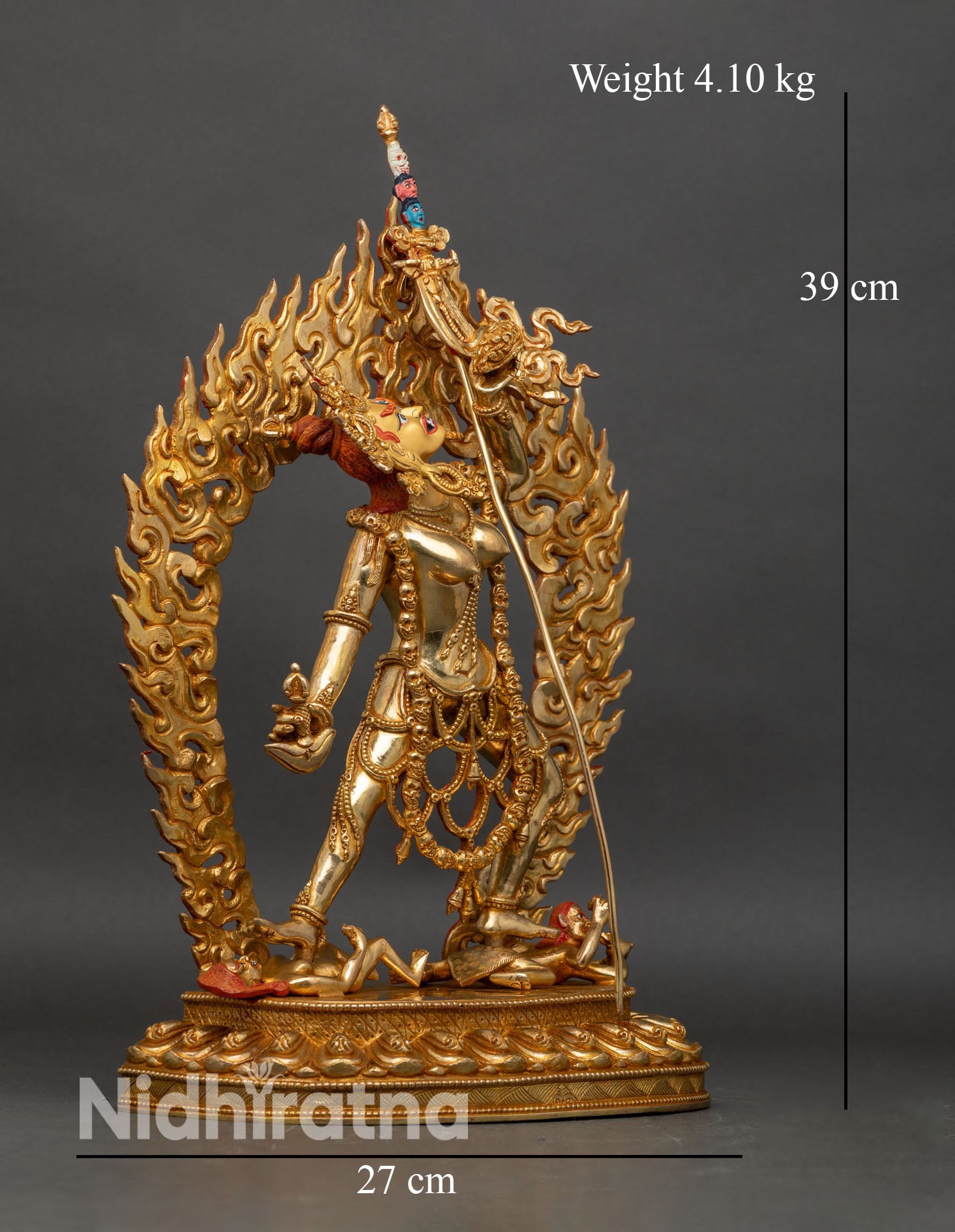 Side view of Vajrayogini statue standing on lotus seat subdued figures flaming halo Tibetan art