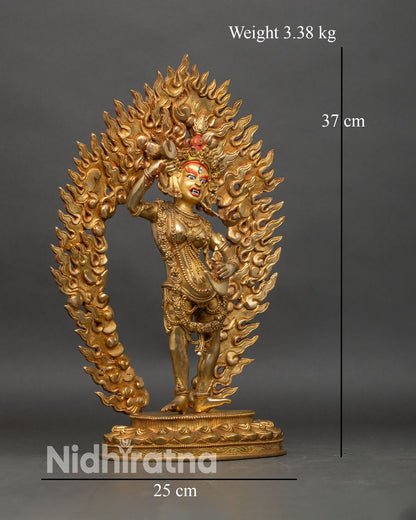 Side view ofYumka Dechen Gyalmo statue holding damaru and kartika knife gold gilded