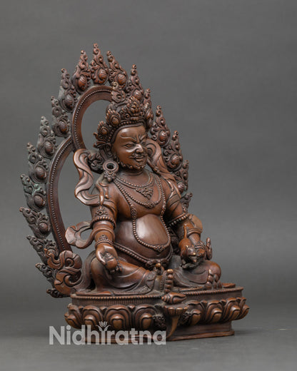 Side view of Dzambhala statue showing ritual staff and trident, handcrafted in Patan