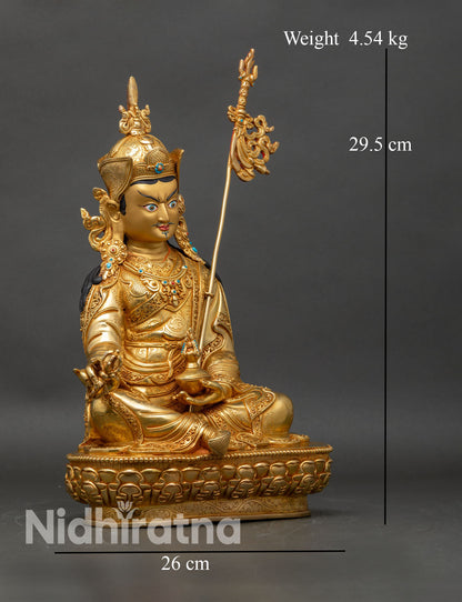 Side view of Guru Rinpoche Statue ornate floral robes khatvanga trident meditation altar Tibetan decor