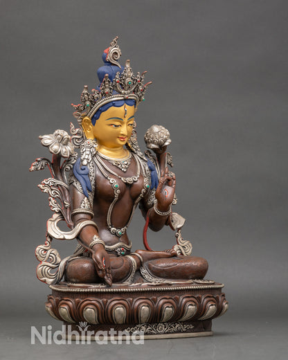Side view of White Tara statue on lotus throne for meditation and healing practice