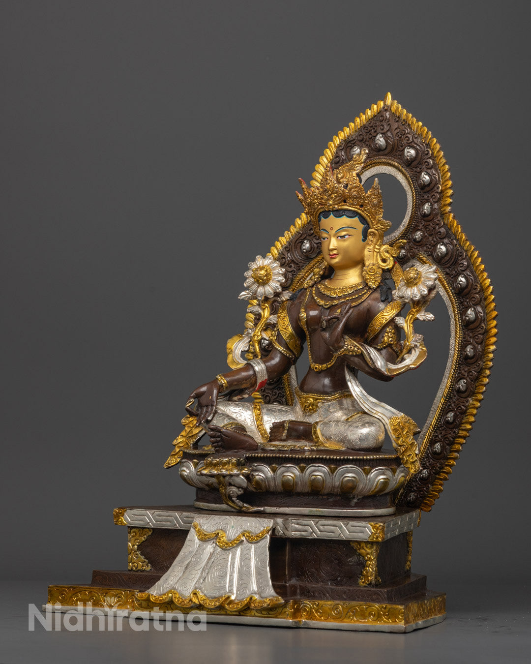 Side-view of Artisan handcrafting a Green Tara statue using traditional Nepalese lost wax method