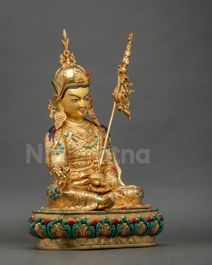 Side view of Guru Padmasambhava statue showing fire-gilded gold layers and ritual symbolism
