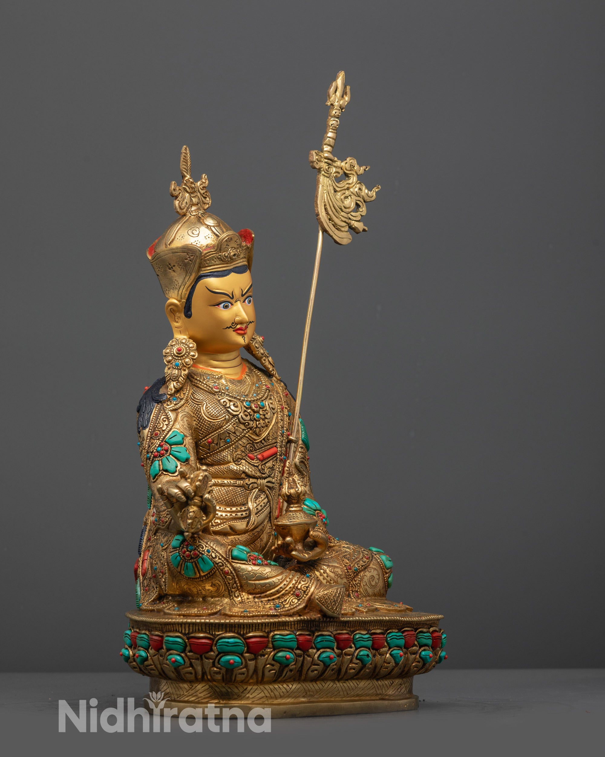 Side Profile of Guru Rinpoche Holding Vajra and Skull Cup 
